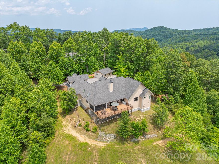 Discover this majestic Saluda retreat, set on nearly 7 acres of pristine land & over 3 acres cleared. Meticulously maintained and thoughtfully upgraded boasting a whole-house generator for peace of mind in any weather, an RV-ready set up with electrical hookups next to the heated detached garage. Garage has it's own propane tank and a mini fridge stocked and ready for hanging out, work-shopping, or parking, in any season. Soak in BIG mountain views from the expansive back deck made with durable Trex board and a screened-in porch designed for entertaining. Enjoy surround sound speakers around the gas fire as you kick your feet up and enjoy the game or the epic sunsets! With the classic luxury of large rooms, 2 gas fire places, vaulted ceilings & a classic kitchen with polished granite counter tops, you'll never want to leave. 4 miles to downtown Saluda, 10 miles to Hendersonville, 20 miles to AVL & Asheville Regional Airport for endless entertainment, fine dining, and outdoor adventures. HOA says Short Term Rentals and goats are allowed. Furniture is negotiable. Check out the attachments for a Home Feature Sheet and How to Experience Saluda, NC. It's a gem of the mountains!
