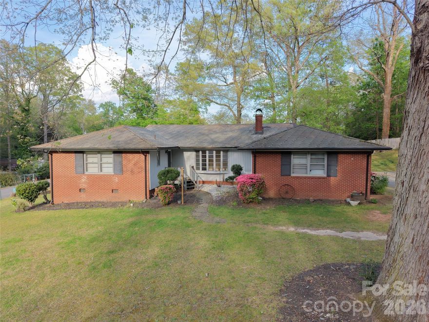 SPACIOUS 3 BEDROOM, 2 BATH, 2,306+/-SF BRICK RANCH, CONVENIENTLY LOCATED TO SHOPPING, GROCERY, AND DINNING.    Large 21' x 20' oak paneled family room with large brick fireplace, beautiful bay window & hardwoods flooring! This house offers a kitchen full of cabinets, island cooktop, black wall oven, dishwasher, refrigerator & large pantry! Living room & dining room with built-ins and custom closets. Huge multi-purpose mud room with laundry. Two storage buildings located at the back of the property.