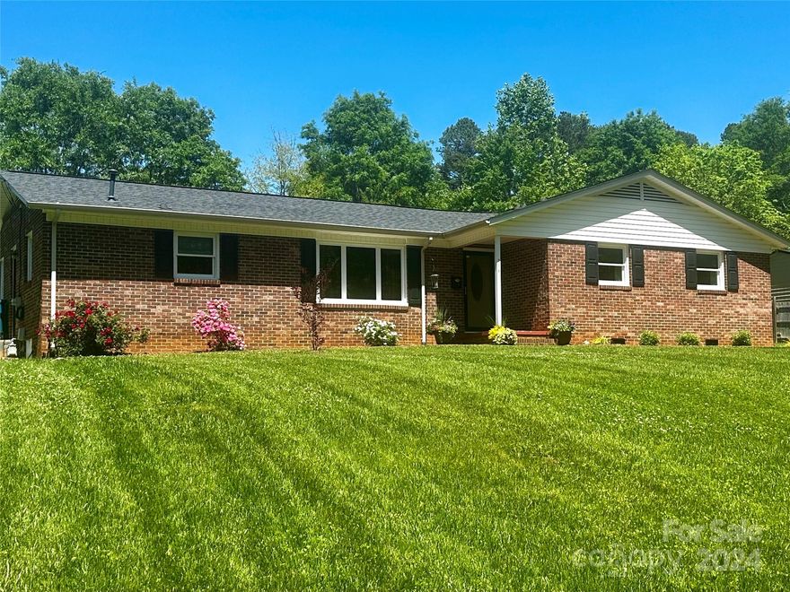 Marvelous Make over!  Come check out all the great updates in this all-brick ranch in lovely NE Hickory!  Very nice floor plan with large den opening to breakfast/dining area.  Den offers brick fireplace and French doors open to patio and carport area that is at the back of the house.  Cozy galley kitchen with new countertops, subway back splash and new appliances. Large laundry room also functions as utility room.  Large family room off of foyer, spacious full hall bath, two good sized bedrooms and a fantastic primary with a nice, updated bath, including a tiled walk in shower with pebble flooring.  Beautiful, new flooring throughout, newer windows, amazing new hvac system, wonderful yard space, quite street and a convenient location.  Two storage closets outside.
Don't miss this one!