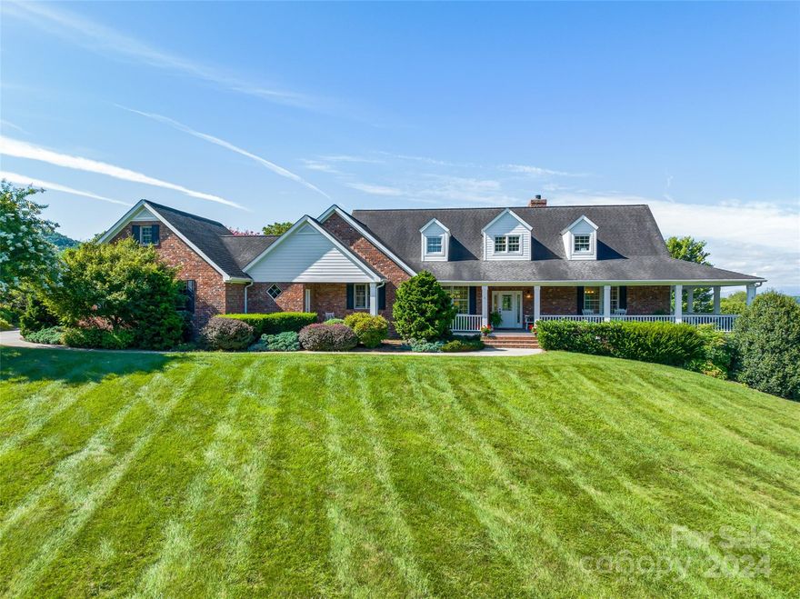 Enjoy long range mountain views from almost every light filled room! Nestled among pastoral and sweeping views of Cane Creek valley to Mount Pisgah, this home welcomes you to country living convenient to Asheville, Hendersonville and the airport. With 4+ acres of land and mature landscaping, there is space to roam, garden, play and enjoy horses. Low maintenance exterior. The wrap around porch is perfect for entertaining family or a crowd. Main level primary suite with sitting area is a perfect owners retreat. Open floor plan, dining, large kitchen
with island and sunroom are perfect gathering areas.  The large laundry room features a sink, walk-in pantry, half bath and access to a mudroom and BBQ porch. The second floor has two bedroom suites and an office or flex room.  The terrace level offers a rec room, billiards room, office and full bath.  Storage galore in both the attic and on the terrace level.  This house has it all including a three car garage with epoxy coated floor.