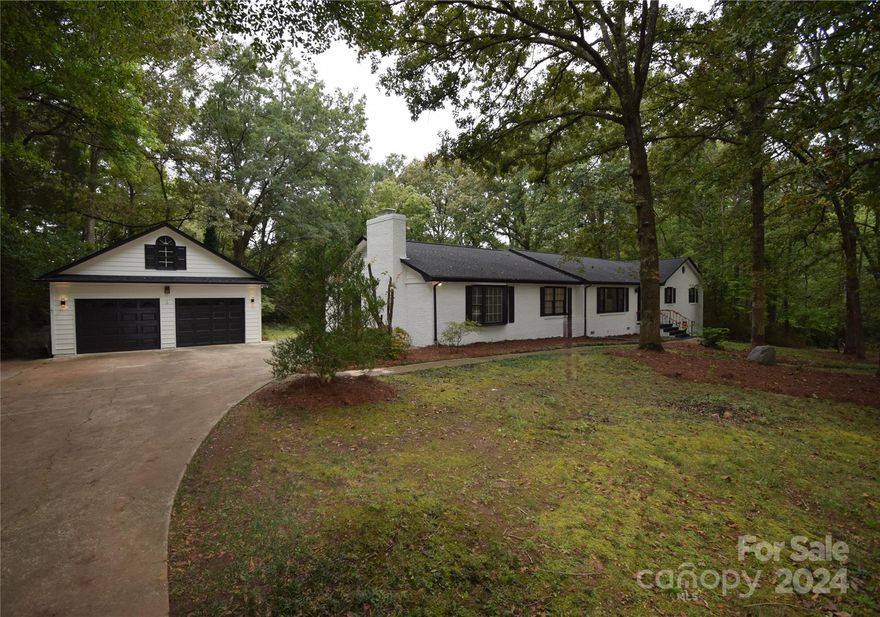 Large ranch style home in a very private setting offering 2.67+/- acres. Lots of updates to include fresh interior paint, flooring throughout, both baths have been updated, updated lighting throughout. The home features a very versatile floor plan with lots of living areas to include a living room and a den and a rec room or man cave. 2 fireplaces in the home. Home has spacious closets, large laundry room with additional cabinet storage. There is a spacious 2 car detached garage and a storage / workshop building that with a little work could have many possible uses. If you are looking for room to spread out and close proximity to I-77, this one is a must see.