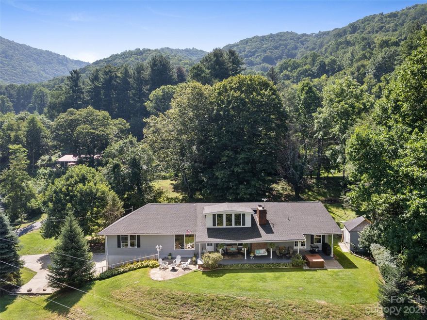 Perched on a hill, just moments from Waynesville Golf Course & award winning Main St Waynesville you will find this sanctuary in desirable Camp Branch neighborhood. Relax on the front porch & take in the Blue Ridge Mountain views as you sip lemonade. This home was made for gathering with multiple living areas, dining areas & outdoor spaces. The recently updated chef’s kitchen overlooking the mountains is a favorite feature. One level living could easily be attainable with master, laundry, kitchen, living-room & multiple dining spaces on the main floor. A large portion of the square footage was added in 2010 (permit on file). Gather around the fire pit & take in the views either before or after soaking in the hot tub. Oversized garage can house more than 4 vehicles depending on the size. Easy, paved access during any season. Short & long term rentals allowed. No HOA- bring farm animals if desired. Additional sleeping quarters upstairs and downstairs. New roof May 2023 - with warranty.