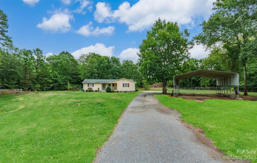 Charming 3 bed 2 bath completely updated & move-in ready! On 1.21 acres, this property offers the perfect blend of privacy & convenience. Enjoy the peace & tranquility of country living while still having access to city water & the option of 2 usable wells on the property. Recent updates include: new heavy vinyl flooring in the kitchen/laundry/dining rooms. New carpet, walk-in shower & vanity in the primary suite. Updated fixtures & ceiling fans throughout & more! New ADT Security & Fire Alarm Monitoring system installed. 1550sqft of living space! As you drive down the long driveway, you will find a 24x40 quad car carport & 16x22 concrete pad which provide a total of 5 parking spaces. Exterior features include a 1.08 area which is fenced and .21 acre in the rear. Back patio looks out into the woods. Don't miss out on this opportunity to own a slice of country living minutes from Downtown Rock Hill and I-77. No access to property without an appointment scheduled with a licensed realtor.