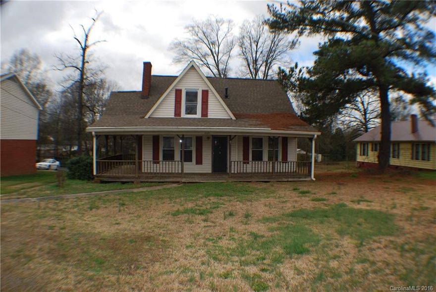 Gorgeous wrap around front porch and large deck overlook large level lot. Hardwood floors throughout much of the living area.  Knotty pine paneling upstairs for warmth.  Tall crawl space ideal for working space. 3-car detached auto shop in rear of property.Sold "as-is" "where-is".  Upstairs is finished with bedroom but not heated and cooled.
