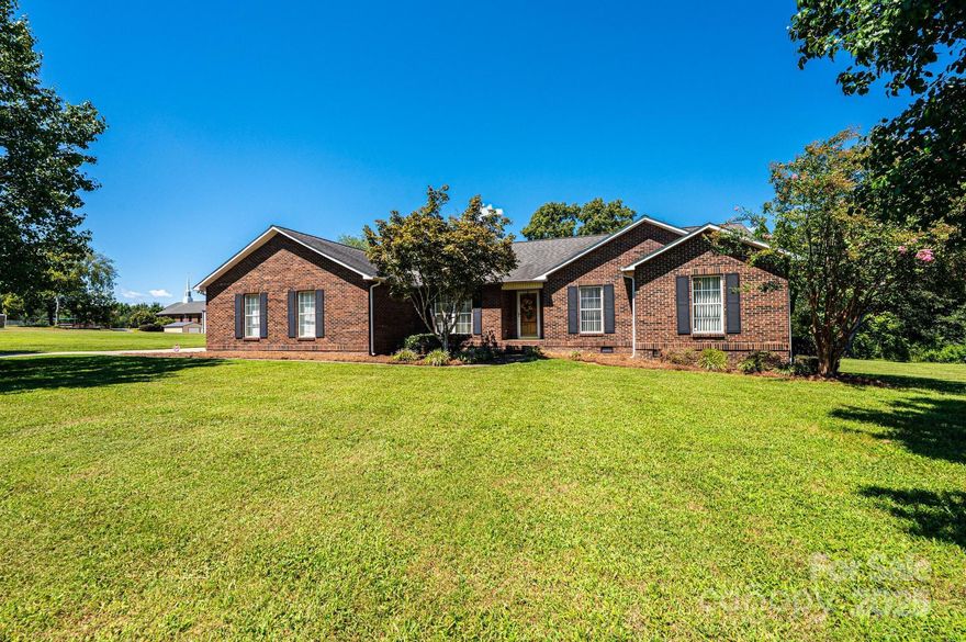 Tucked away in the established Keever Estates neighborhood, this inviting full-brick ranch welcomes you home with timeless charm and thoughtful updates, all on one convenient level. Offering over 2,600 square feet, the layout is designed for both everyday comfort and easy entertaining, beginning with a warm living room anchored by a stone fireplace and stunning vaulted wood ceiling that sets the tone for the home. A split-bedroom floor plan provides privacy, with three bedrooms and two full baths, while a dedicated office offers flexibility for work or hobbies. Enjoy meals in the sunny breakfast room or host gatherings in the formal dining room, then unwind in the bright sunroom, now enhanced with a brand-new HVAC system for year-round comfort. Major updates add peace of mind, including a newly installed architectural roof, a 2019 HVAC system for the main house, and a new crawlspace vapor barrier. Situated on a level .94-acre lot, there’s plenty of space to enjoy the outdoors, along with a 2-car garage featuring a large utility closet for extra storage. The neighborhood’s established feel invites relaxed walks and a sense of community without HOA fees. Convenient to shopping, dining, and with easy access to Denver, Charlotte, Hwy 16, and I-485, this home blends space, comfort, and location beautifully. A special opportunity to make a well-cared-for home your own.