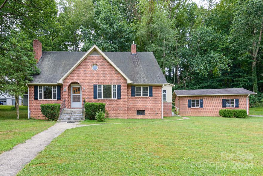 Discover this delightful 1948 brick home, perfectly situated just 1 mile from downtown Waynesville. This property boasts classic charm with its stunning oak trim and original hardwood floors that bring warmth and character to every room. Set on over 3/4 of an acre, there's plenty of outdoor space for gardening, relaxation, or entertaining. The detached garage offers additional storage or workshop potential. Enjoy the convenience of being close to shops, dining, and the vibrant community of downtown Waynesville while still enjoying the tranquility of a spacious lot surrounded by trees. Don’t miss this unique opportunity to own a piece of Waynesville’s history! HOME IS LISTED WELL BELOW RECENT APPRAISAL VALUE and is sold as/is!