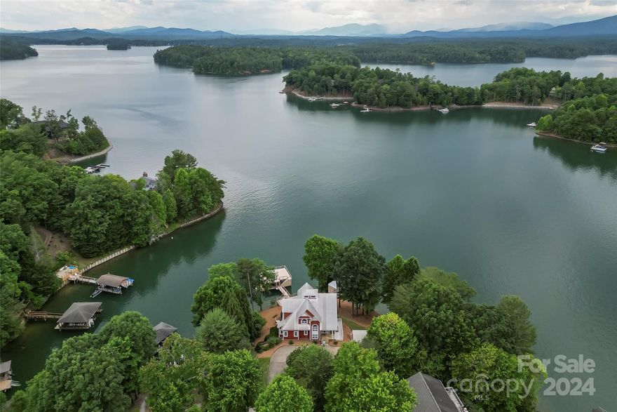 Enjoy the most amazing views looking out over Lake James.   This lakefront home is perfect for entertaining family and friends. Two main level ensuite bedrooms, open great room with cathedral ceilings, fireplace, dining area with views for miles.. Screened porch with fireplace.  Full deck overlooking the lake.  Upper level private primary suite with walk in shower, soaking tub, huge walk in closet, private deck and long water views.  Head to the lower level for family room, second kitchen, private office, ensuite bedroom/bath, billiard area, laundry and half bath.  Full stone patio and fireplace. Easy walk to the waterside.  Two level dock with double slips and jet ski  dock. Detached 2 car garage with upper level storage.   East Shores has community pool and tennis courts and is just a 20 minute drive to Morganton shops and services.  Minutes to Fonta flora Trail, Lake James State Park and Pisgah National Forest for hiking, camping & mountain biking.