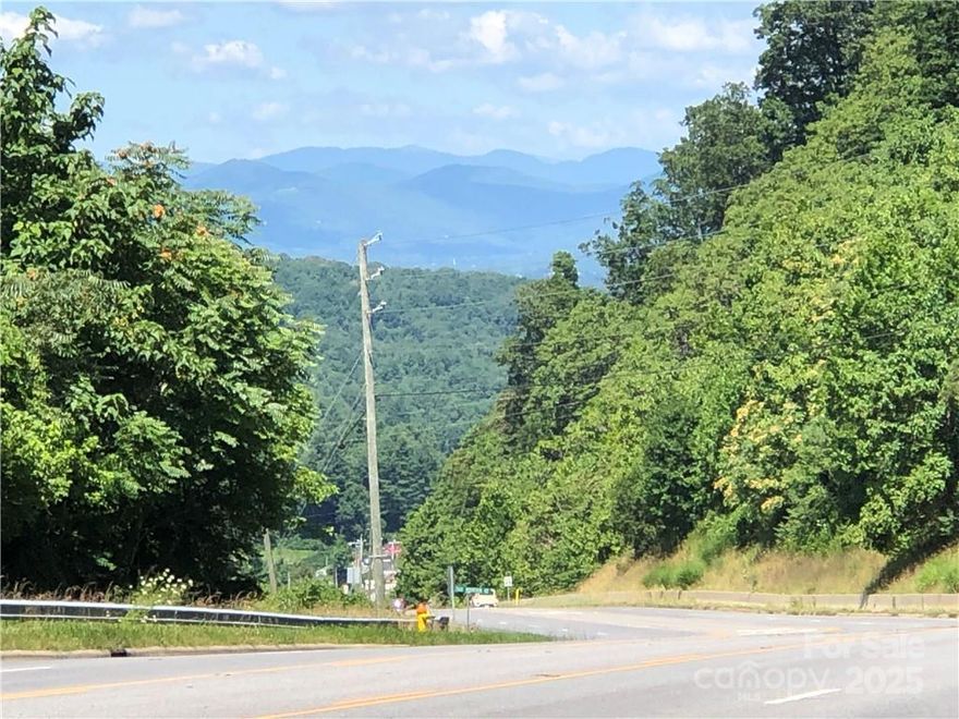 In Biltmore Township bordering Fairview Township..  Located on 5 lane Hwy 74A Scenic Highway and Cedar Mountain Road. 3 miles to I 40, I 240, Blue Ridge Parkway & Asheville. Total of 1800 feet of road frontage (900 feet on Hwy 74A, 600 feet on Cedar Mountain Road and 300 feet on Atherton. Public water with fire hydrants on all three roads. Public sewer with 97,500 gallons per day allocation for 250,000 sf of commercial and 800 bedrooms, gas, electric, cable phone on prime corner location at the top of Minehole Gap with over 20,000 cars per day.  Double access curb cut on 5 lane Hwy 74A. Long range views. Previously under contract for $1,100,000 for assisted living facility. Owner Broker would consider joint venture. Price lowered another $60,000.