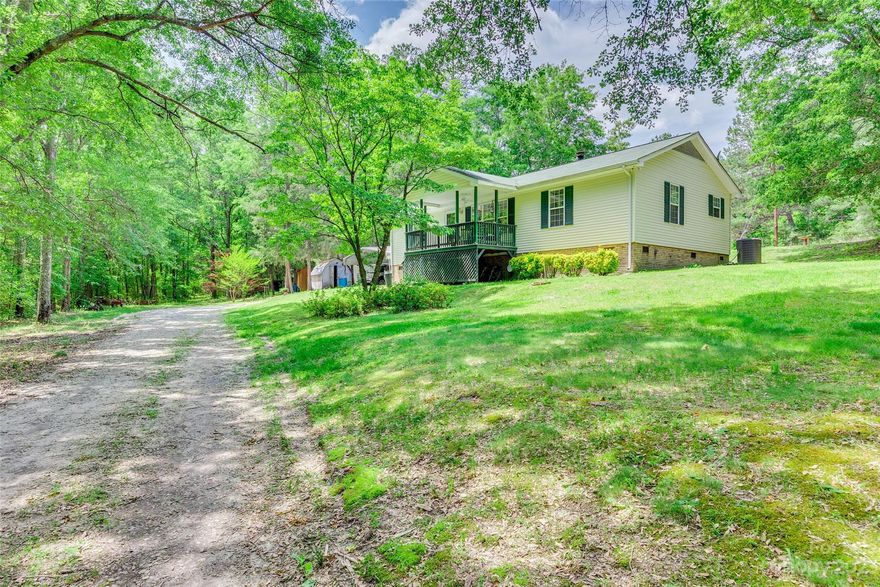 You will love the peace and quiet of this country setting!  The long, gated driveway offers privacy to almost 5 acres of land.  Once inside, you'll find this beautiful 3 bedroom, 2 bath home shows like new, and has been well maintained by one owner.  The large living area and eat in kitchen invite you to welcome guests. You'll appreciate the front and back covered porches, as well as a small horse stall, fenced pasture, carports, and outbuildings.