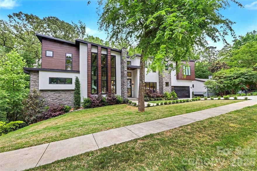 Step into modern comfort in this striking contemporary home nestled in sought-after Huntingtowne Farms. Designed with clean lines and walls of windows in nearly every room, this 4,401 sq ft, two-story residence is filled with natural light and immersed in its serene, tree-lined setting.  

A dramatic 26-foot ceiling defines the Great Room, where real cedar beams extend seamlessly from the exterior to the interior, creating a warm architectural statement. The open-concept layout flows effortlessly, anchored by a stunning kitchen featuring an expansive island, designer custom cabinetry, and ideal connectivity for entertaining and everyday living.

The main-level primary suite offers a true retreat, complete with a spa-inspired bath showcasing a walk-in shower and soaking tub combination—perfect for relaxing, luxury spa days.

Upstairs, a floating staircase leads to three additional bedrooms, a second laundry room, and a standout bonus room currently styled as a dressing room—ready to impress and perfect for creating your own lifestyle haven.

Enjoy outdoor living on the back deck, where grilling feels like you’re perched in a private treehouse within the canopy. Ideally located near SouthPark, this home offers a rare blend of modern design, natural beauty, and everyday convenience.

Open House this Sunday, May 3rd from 1PM to 3PM.