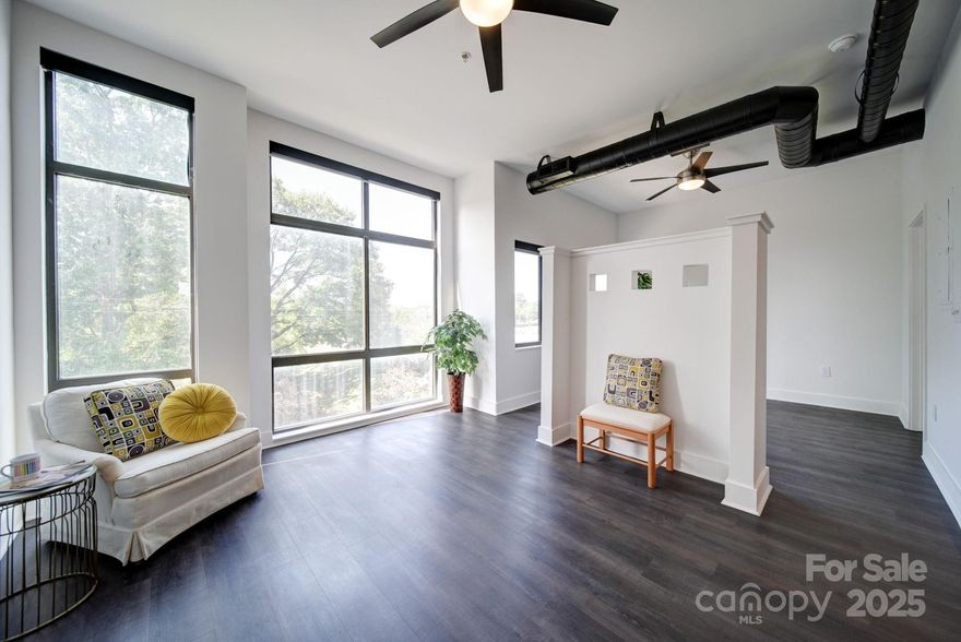 Welcome to the heart of Charlotte! Experience vibrant Center City living in this sun-drenched Uptown condo! This beautifully maintained 1-bedroom, 1-bath condo on the 3rd floor offers expansive windows that flood the space with natural light, and provide stunning Uptown skyline and sunset views. Freshly painted and move-in ready, this open-concept home features soaring ceilings, updated flooring throughout, and a well-designed layout that maximizes comfort and functionality. The kitchen boasts an eat-in counter, generous pantry closet, and seamlessly flows into the spacious living area - complete with built-in desk and shelving, ideal for working from home. The bright bedroom includes an en-suite bath with a glass walk-in shower and a massive walk-in closet. You'll also enjoy the convenience of in-unit front-loading washer and dryer with extra shelving for storage. Reserved parking and elevator access make city living effortless. Step outside your front door and immerse yourself in premier dining, shopping, and entertainment. Just blocks from Bank of America Stadium, Belk Theatre, AvidXchange Music Factory, Camp North End, and more. With quick access to I-77 and Charlotte Douglas International Airport, this turnkey home is perfect for professionals, frequent travelers, or anyone seeking a low-maintenance lifestyle in the center of it all. Don’t miss your chance to own a slice of Uptown Charlotte!