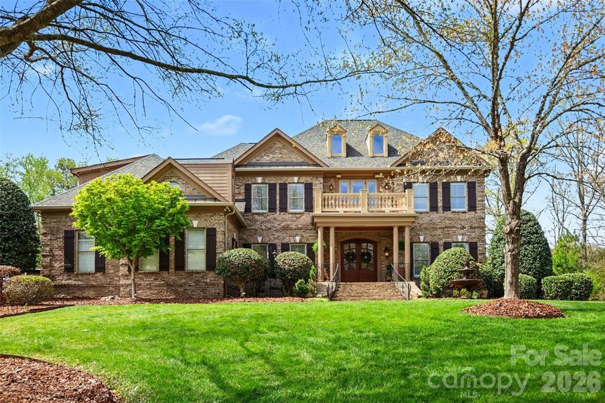 Welcome to Quintessa, one of Wesley Chapel’s most sought-after gated communities. Tucked away on a nearly 1-acre cul-de-sac lot, this home offers 20 ft ceilings with custom windows and in close proximity to Wesley Chapel and Weddington schools.

Appraising for $1,550,000 built with timeless style and thoughtful craftsmanship, the home showcases custom millwork, designer lighting, built-in cabinetry, rich hardwood floors, and a stunning double-sided stone fireplace that anchors the living spaces. The chef’s kitchen is built for both everyday living and entertaining, seamlessly flowing into the breakfast area, keeping room, and a dramatic two-story great room with a gas fireplace overlooking the backyard retreat.
The main level features a spacious owner’s suite along with a secondary master/guest suite, ideal for multi-generational living or hosting guests. Also on the main floor: a private office, lounge area, dry bar, and laundry room.

Upstairs, you’ll find two additional bedrooms, each with an ensuite bath, a grand balcony overlooking the gorgeous property, 3-person sauna, plus a large bonus room offering flexible living space.

Step outside to your private fenced-in backyard oasis which includes a heated saltwater pool and hot tub that are surrounded by a safety fence to protect the little ones. The home has exterior and interior surround sound, a covered back porch and screened in sunroom that are perfect for year-round enjoyment. Additional highlights include multiple walk-in storage rooms, an irrigation system, and countless upgrades throughout.