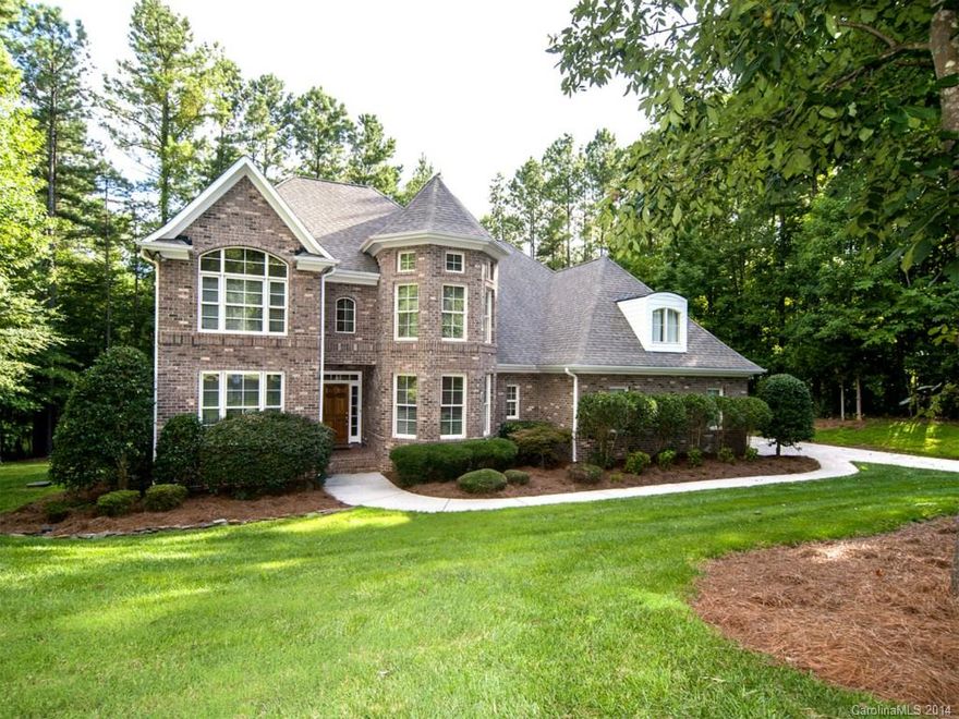 Custom home in exclusive gated community on Lake Wylie. Launch kayaks/canoes from backyard or go across the street to deeded boat slip for deep water. This house has a dramatic two-story Great Room with coffered ceiling. Open kitchen has granite, stainless, hardwoods, breakfast area and two pantries. Large Owners suite on the main with  enormous walk-in shower, whirlpool, dual sinks and large closet. Upstairs bonus room with mini kitchen/bar area. Beautiful .83 acre lot. Must see to appreciate.