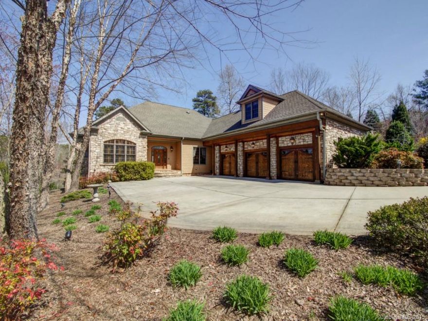 Exquisite waterfront custom home overlooking State Park. Quiet & very private setting. Covered boat slip; deep water. Covered seating/dining area at waterfront, as well as a boardwalk along water's edge. Gradually sloped yard is perfect for an infinity pool. House exterior is hardiplank shingles, stone & heavy beams. Two screen porches, 3-car garage, two stone fireplaces, second living quarters. 10-ft ceilings and 8-ft doors. Lush landscaping. Library w/coffered ceiling.  Casual elegance galore!