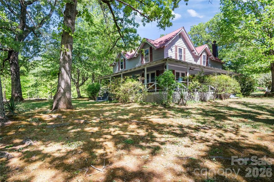 Charming Farmhouse built in 1899 and has been loved for over 100 years. Home has a wraparound porch and patio looking out over the 8.4-acre lot, which is mostly cleared and ready for livestock, farming, or future development. Step inside this timeless treasure and you'll notice the hustle and bustle of life just float away!  The main floor has a large family, dining, and living room set up with doors that lead out to the porch, a large open kitchen with a breakfast nook, with windows on all sides, a high countertop for a couple of chairs, and a full bathroom with a jetted tub. There is also one bedroom on the mail level. Upstairs you have 2 or 3 more bedrooms and large full bathroom!  Property boasts a circular driveway, a carport, a barn, and a workshop.  Most of the 8 acres is cleared already - and Fir or Cypress trees were planted on the boundary lines, providing added privacy!  Home also has mountain views from the back patio!!  This is a one-of-a-kind home and property, located in between Tryon & Columbus, NC, just a few minutes from either town; close to I-26, HWY 74, TIEC, St. Luke's Hospital, and shopping.  Greenville, Asheville and Charlotte are all approx. an hour away.  Quiet, Private Retreat - could this be your forever home?  Set up your appointment today!!