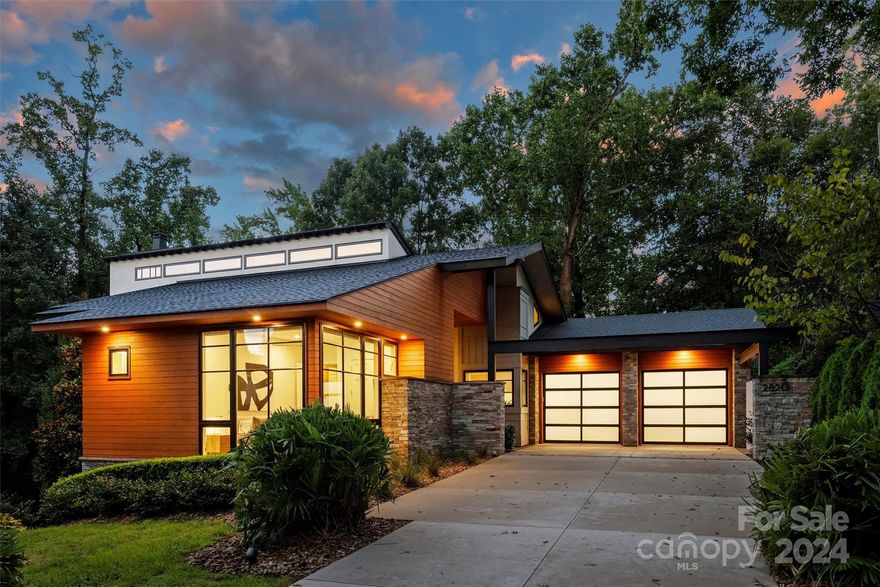 Stunning west coast style Shrader Design custom home in the heart of Myers Park. Home features bright, open flrpln w/vaulted ceilings, gorgeous trim detail & spectacular Catalina doors & custom designed architectural Pella windows. Kit w/Leathered Rio Café Quartzite ctops, under cab lighting, Miele appls & pantry. Spacious living & dining w/multi-panel glass folding drs to lrg balcony w/gas grill-perfect for entertaining. Amazing Primary Suite w/vaulted ceiling, beam detail & sliding doors to private balcony w/gorgeous wooded view. Bath w/floating vanity & lrg window, shower w/full tile surround & soaker tub. Oversized screened porch w/sink & bev frige. Lrg rec rm & 2 beds & full bath finished by TriSquare. Dropzone, laundry & dog wash. Huge walk-in storage. No detail overlooked-solar photovoltaic systm & Tesla home power backup systm, designed for elevator shaft, garage can accommodate lift to hold 4 cars in total & prewired for EV charger! Exceptional contemporary-home move in ready!