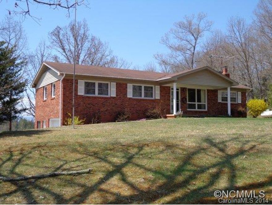 Watch the sun rise and from your front porch and set over the mountains from the Sunroom. Well maintained brick ranch with long range mountain views year round in a peaceful private setting. Beautiful HW floors. Detached workshop. Unfinished basement ready for expansion.  Close to downtown Weaverville.  Priced to sell!!