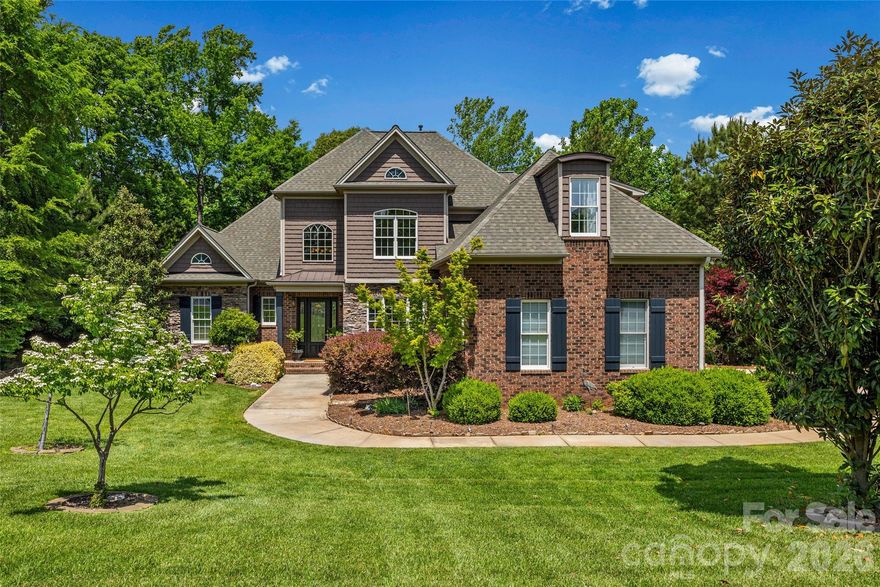 Welcome to this gorgeous custom built brick & stone home with large, ready to complete walk-out basement, perfect for additional living space, nestled in sought-after Masons Crossing, surrounded by the natural beauty of Lake Wylie!! This property on 1.05 acres offers exceptional privacy with a tree-lined backyard, seasonal water views, and stunning landscaping. Step inside to find hardwoods and tile throughout the main level, complemented by rounded wall corners, custom crown molding and abundant natural light. This home has been freshly painted in a neutral color enhancing the open floor plan. The impressive two-story vaulted entry opens into a spacious family room with a remote control gas fireplace accented by travertine tile, along with a vaulted living room. The open floor plan is perfect for both everyday living and entertaining. The gourmet kitchen features an island, custom cabinets, granite countertops and a wine bar. The primary suite is located on the main level and features a double tray ceiling and a spa-like bathroom with a jacuzzi tub, walk-in shower, and generous storage. Upstairs offers two additional bedrooms and a third bedroom or bonus/entertainment room with a wet bar and surround sound—ideal for hosting or relaxing. Outdoor living is just as impressive with an oversized, weatherproof trex deck offering three access points, multiple sitting areas, and peaceful views of trees and seasonal lake scenery. Enjoy whole-home audio with six sets of built-in speakers and the convenience of a central vacuum system. Additional highlights include: a 3-car side-load garage with extended driveway parking, a 1,984 sq ft basement, framed and plumbed with extra-high ceilings, durable 2x6 construction, abundant storage, six windows, and two separate patio entrances, a fire pit area and wiring ready for a hot tub. Recent Updates & Features: New well pump (2024), New 119.5-gallon water pressure tank (2023) Roof replaced (2021) Whole-house water softener system Ecobee programmable thermostat, In-ground irrigation system and NO HOA! This home offers a rare combination of privacy, space, and custom features in a prime Lake Wylie location!! Low taxes and zoned for the new Lake Wylie High school!