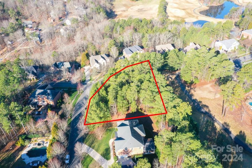 Embrace luxury living on this coveted .65-acre elevated corner lot within the prestigious Tega Cay Golf Club community. Build your dream home amidst with golf course views to the back, and long range lake views to the front this one is special! Enjoy access to world-class amenities including golf course, clubhouse, tennis, playgrounds, walking trails and community events. Don't miss this rare opportunity to experience resort-style living in with NO HOA in desirable Tega Cay.