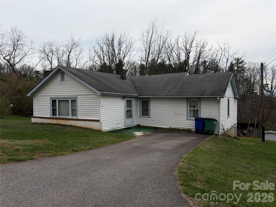 Location, location, location!  Coveted location, walking distance to Downtown Weaverville's restaurants, bakeries, coffee shops and gift shops.  Convenient to everything. Brick wood burning fireplace for those cool nights. Side covered patio for sipping morning coffee.  Maintenance free vinyl siding. This home is ready for your upgrades and creative touches.  A little over 1 acre with plenty of space for pets, or gardening.  This is a one of a kind opportunity. This is an estate sale and being sold AS-IS.