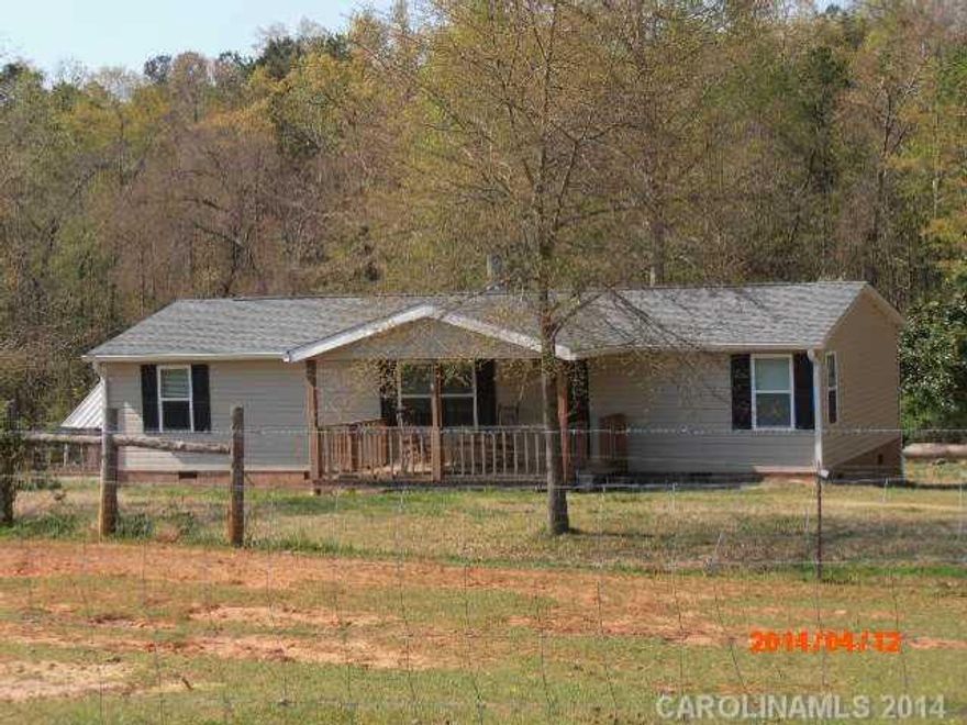 Bring your horses! 7 Acres, 3 bdrms, 2 bths, Doublewide w/split bedroom plan; laundry room, family room w/fireplace, kitchen and dining combo, large covered front porch and big back deck, new paint, and flooring. New Vinyl siding and windows, the roof was new in 2012. Barn has 3 stalls and a loft, pasture is fenced, stream and woodlands. Plenty of Parking! Move in Ready! Beautiful setting! Agent related to seller.