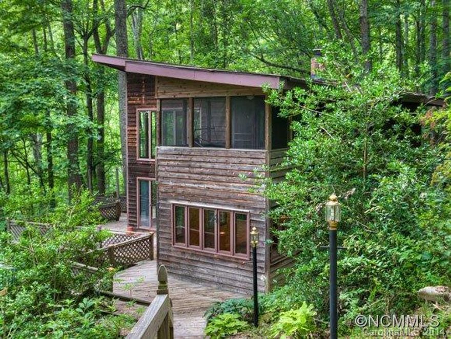 Private, serene, contemporary mountain chalet with soaring ceilings and lots of glass.  Located near the entrance to Fairview Forest and only minutes to 74A with easy access to Asheville.  Originally built from Southern Living plans, this unique home features a very functional floorplan and lots of room for guests or hobbies. 22' foot ceilings in great room, wood stove in basement bonus room, new well (spring available). Decking on all 4 sides.