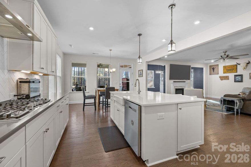 Luxury Living with Ultimate Flexibility in Paddlers Cove and minutes to Charlotte, NC!

Welcome to a residence where refined design meets unparalleled scale. Nestled in the heart of Lake Wylie within the highly sought-after amenity rich Paddlers Cove community, this 2022-built "Stonehaven" model by DRB Homes is more than just a house—it’s a sanctuary designed for the modern, multi-generational family and is ready for your family or relocation!  

The Main Level: Sophistication & LightStep through the foyer and into an open-concept masterpiece. The gourmet kitchen is a chef’s dream, featuring quartz countertops, a massive sitting island, a 5-burner gas cooktop, and a stylish butler’s pantry leading to the formal dining room. The sun-drenched family room, anchored by a cozy fireplace, flows seamlessly into a vaulted morning room—perfect for your early coffee while overlooking the wooded backyard.Accommodations & Private Suites

The Primary Retreat: Located upstairs, this massive suite features a tray ceiling and a spa-like deluxe bath with dual vanities, a deep soaking tub, and a semi-frameless glass shower

Secondary Living Quarters: A rare find! The full finished walk-out basement serves as a private living suite, complete with its own separate entrance, full kitchen, living room, bedroom, and full bath. It’s the ideal setup for in-laws, long-term guests, or an elite entertainment hub.

Work & Play: A dedicated home office with French doors provides the quiet you need for remote work, while the upstairs loft offers a secondary gathering space for the kids.

Your Outdoor Oasis

Step outside to your extended 20-foot covered deck or the lower-level patio to find a fully fenced, tree-lined backyard. After a long day, unwind in the above-ground hot tub or gather around the fire pit for s’mores under the stars.  Living here means more than just a beautiful home; it’s about the community amenities: Two sparkling community pools & clubhouse.Direct Lake Wylie access and walking trails.  A golf cart away from Field Day Park (pickleball, sports fields, and playgrounds).  On and near cul-de-sac, low traffic, private backyards. 

Zoned for the award-winning Clover School District (Crowders Creek Elementary is right around the corner!). This property stands out not just for its size, but for its versatility. Minutes from restaurants, local activities, shopping, grocers, and a short drive in to the NC border!

The separate living quarters in the basement are a game-changer for families relocating with extended relatives. 

Plus, with a low VA/FHA assumable interest rate (5.375%) available, this is a strategic financial opportunity you won't find every day.

Key Property Features at a Glance:
Multi-generational living
Built: 2022 (Like-New Construction)
Square Footage: 5,446 (Total Living Area)
Lot: 0.19 Acres (Cul-de-sac, Fenced, Wooded View)
Parking: 2-Car Garage + 4 Driveway Spaces
Extras: Dual laundry rooms, 2 kitchens, wet bar, fiber-optic internet ready.
