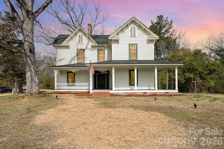 This charming 19th-century Victorian farmhouse, located near Lake Tillery, seamlessly combines historical charm with modern upgrades. Situated on a private 3.77-acre lot, this home features a picturesque wrap-around porch adorned with original doors and decorative trims. The property boasts additional historic structures including an active wellhouse, smokehouse, barn, and chicken house. The spacious backyard offers a peaceful, secluded retreat perfect for entertaining or simply enjoying the surroundings. Inside, original hardwood floors grace the main living areas and bedrooms, preserving the home’s timeless character, while a newer dual-zone HVAC system and roof provide modern comfort and peace of mind. This home offers 5 bedrooms, though one bedroom does not include a closet. The property is also subject to protective historic covenants. Conveniently located near Piney Point Golf Course and the scenic shores of Lake Tillery, you’ll enjoy easy access to local restaurants, a public boat ramp, and nearby storage facilities making it ideal for both full-time living or a weekend retreat.