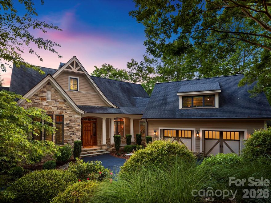 Nestled in the heart of the ultra-exclusive Cliffs at Walnut Cove, this transitional mountain masterpiece offers a rare synthesis of high-altitude privacy and effortless access to premier amenities. Perfectly positioned midway between the community’s front gate and the award-winning clubhouse, the residence serves as a serene sanctuary within Arden’s most prestigious gated enclave. Residents here enjoy a world-class lifestyle centered around an 18,000-square-foot wellness center featuring indoor and outdoor pools, tennis courts, and a luxury spa. The community’s crown jewel remains the Jack Nicklaus Signature golf course, complemented by the social vibrancy of "The Tavern," an elegant hub for fine dining and member events. Bordering the Pisgah National Forest and located just minutes from the Blue Ridge Parkway and Asheville, this location provides the ultimate North Carolina mountain experience.

The home’s architecture, a sophisticated "Mountain Modern" design, is immediately apparent from the striking exterior, which blends textured stone, clean horizontal lines, and expansive glass to create a residence that feels both grounded and ethereal. Upon entering through the custom walnut front door, the foyer opens into a voluminous great room where rich hardwood flooring and a floor-to-ceiling stacked stone fireplace set a tone of understated luxury. The open-concept layout is anchored by a top-caliber chef’s kitchen, featuring a massive granite island with built-in seating, professional-grade stainless steel appliances, and warm wood cabinetry. High vaulted ceilings with integrated timber accents enhance the sense of space, while large glass sliders lead to a screened porch equipped with a grilling station and seating area, perfect for year-round entertaining against a backdrop of rolling mountain views.

The primary suite on the main level is a true retreat, designed with raised tray ceilings and expansive windows that invite the outside in. The accompanying owner’s bath is a masterclass in spa-inspired design, featuring dual vanities with custom cabinetry and a massive glass-enclosed walk-in shower. For those working from home, the dedicated office provides a refined environment with large windows overlooking the lush landscape. Every corner of the residence reflects meticulous attention to detail, from the gallery hallways and spacious guest suites to the two dedicated wine cellars on the lower level, which ensure privacy and comfort for visitors. The outdoor living spaces are equally impressive, boasting a sprawling stone terrace and an elevated deck that seamlessly merge the home with its natural surroundings. This property is not just a home, but a gateway to the unparalleled lifestyle and natural beauty of Western North Carolina.