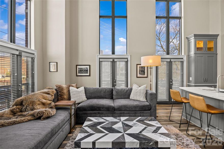 Luxury living in the heart of South End! This beautifully designed 2 bedroom, 2 bath home offers 1,277 square feet of high end style and functional living space in one of Charlotte’s most sought-after neighborhoods. The two-level floor plan creates the perfect blend of openness and privacy. The main level features a spacious living room that flows seamlessly into the kitchen making it ideal for entertaining or everyday living. Complete with premium appliances, sleek finishes, and oversized windows with ample natural light. A secondary bedroom and full bath on the main level offer the perfect space for guests or a home office. Upstairs, the private primary suite is a true retreat, including a versatile loft space overlooking the living area below. Whether you need a workspace, reading nook, or additional lounge area, this flexible layout adapts to your lifestyle. Enjoy the convenience of two assigned parking spaces with entry FOB, plus access to a community rooftop terrace with stunning skyline views — the perfect spot to unwind or gather with friends. Experience everything South End has to offer just outside your doorstep including top-rated restaurants, breweries, boutique shopping, the Rail Trail, and light rail access. With its unbeatable location, premium amenities, and thoughtfully designed layout, 115 E Park Ave #101 delivers elevated urban living at its best!