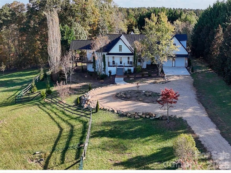 Set on more than 12 picturesque acres just minutes from the world-renowned Tryon International Equestrian Center, this exceptional farmhouse estate offers an unmatched blend of luxury mountain living, equestrian functionality, and incredible investment potential. Whether envisioned as a private family compound, boutique event venue, luxury Airbnb retreat, or working equestrian property, the possibilities here are truly endless. Designed with horse enthusiasts in mind, the property features three fenced pastures and a well-equipped two-stall barn complete with tack room and hay/shavings storage, creating a turnkey setup for equestrian use. The expansive grounds are beautifully landscaped and centered around one of the property’s most breathtaking features — a luxurious custom creek and waterfall installation stretching over 170 feet and showcasing more than seven cascading waterfalls, creating a truly serene and unforgettable setting rarely found in the area. The spacious 7-bedroom, 5-bathroom residence offers exceptional flexibility for multigenerational living, guest accommodations, retreat-style hosting, or income-producing opportunities. Several of the bedrooms can easily serve as bunk rooms, offices, fitness spaces, media rooms, or private guest suites, allowing the home to adapt seamlessly to a variety of lifestyles and business ventures. Adding even more versatility is the private 1-bedroom, 1-bath apartment above the garage — ideal for guests, caretakers, rental income, or extended family living. Enjoy peaceful mornings and mountain sunsets from the expansive side deck overlooking the rolling countryside and surrounding mountain views. Located just a short drive from one of the country’s premier equestrian destinations, this rare Western North Carolina property combines natural beauty, privacy, functionality, and commercial potential in one extraordinary offering. Additional highlights include brand-new siding, fresh exterior paint, making this property move-in ready while still offering room to personalize and expand its vision. Furnishings negotiable. Approximately 1,706 square feet of total HLA unpermitted.
