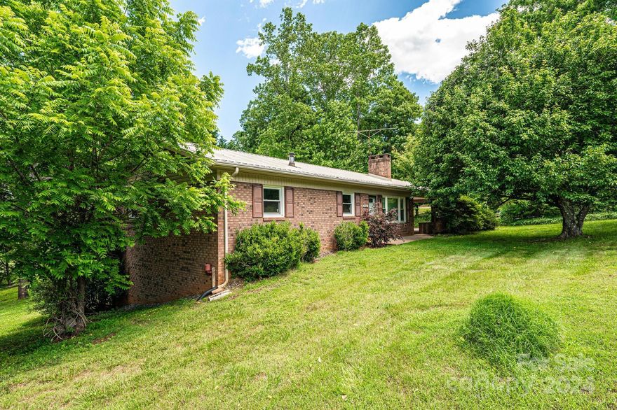 Have you been dreaming of country living in a convenient location? This quintessential solid brick ranch on 3/4 of an acre features new LVP flooring throughout. With 3 bedrooms and 1 full bath on the main level along with a cozy living room, kitchen and dining area, you are sure to feel right at home the moment you walk through the door. The partially finished basement includes a generous den area and another full bathroom. The unfinished portion of the basement offers a great space for a workshop or a home gym. The oversized carport is great for parking or hanging out in the shade on the hot summer days. There is room for plenty of storage with 2 spacious storage buildings on the property. This is one you don't want to miss!