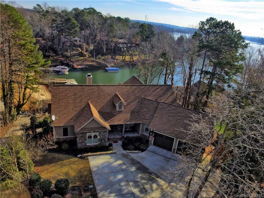 LAKE LIFE! Beautiful 4 BR 4 BA waterfront home in the sought after Tega Cay community. Open floor plan home features gourmet kitchen with gas cooktop, granite counters and center island. Great room has gorgeous stone fireplace, built-ins and generous lake views. Master on main with tray ceiling and bath with dual sinks, garden tub and separate shower.  Basement features large rec space, wired media room, fitness room and 5th bedroom with closet installation. Lots of storage space! Entertain around the salt water pool, outdoor kitchen and ample deck/patio areas, boat dock with gazebo and swimming beach. Close to dining/shopping, golf and minutes from Uptown. A must see lakefront property at this value price.