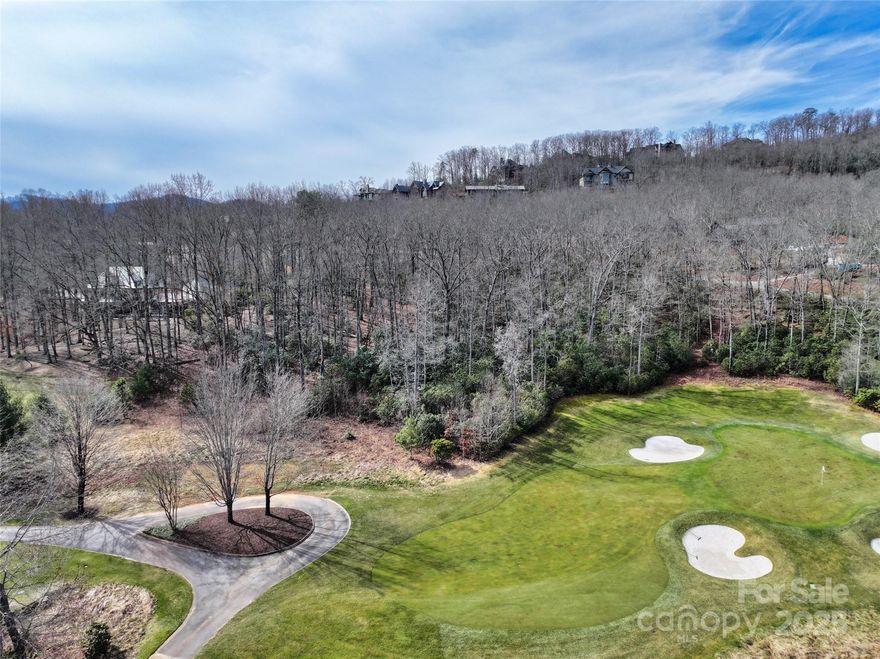 Extensive tree work and underbrush clearing unlocked year-round mountain and golf course views on this easily-buildable parcel in the most prestigious gated community & golf course in Asheville. Survey showed more favorable boundaries than anticipated, with even better views of the course. This large, gently-sloping estate lot offers a wide range of optionality to design and build your dream home on the 16th green of the Cliffs at Walnut Cove signature Jack Nicklaus course. Tucked away beneath Pisgah National Forest, this lot offers plenty of privacy w/out sacrificing proximity to all the amenities Walnut Cove has to offer. Imagine sitting on your covered porch early in the morning with a hot cup of coffee taking in views of both the 16th par 3 and the 17th par 5, and the Blue Ridge Mountains and the Parkway in the background. You won't find a better opportunity to build your dream, custom home in the area's most prestigious community!