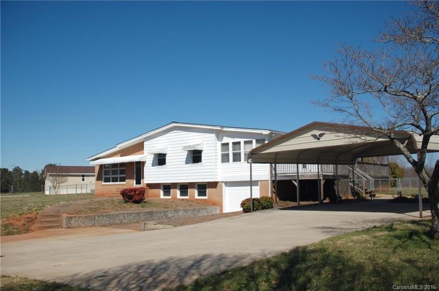 Charming home in impeccable condition. Beautiful vistas all around. Bright & sunny - open plan - Huge dining room area open to kitchen, sun room & great room. Pergo & hardwood floors, new roof & most windows, garage, 2 car carport & huge insulated shop. Deck w/gazebo, fenced yard. Excellent street. Don't miss this one!