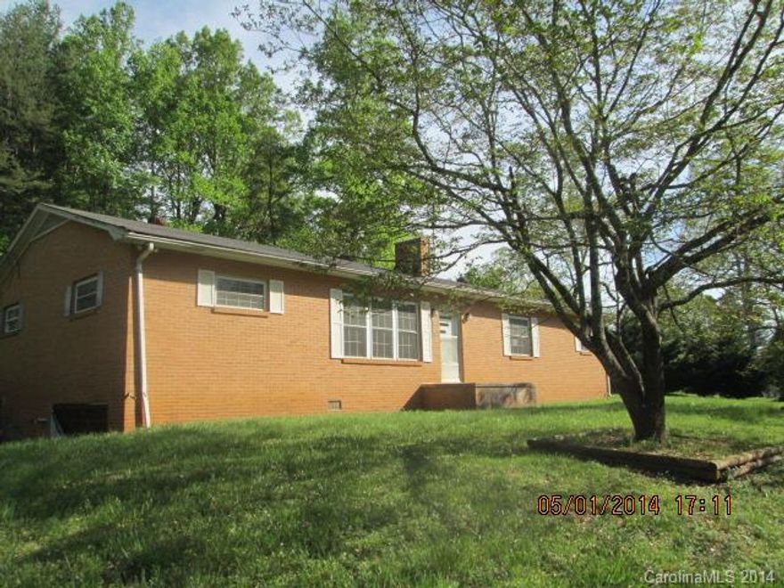 Priced below tax value. Brick ranch with side carport and partial basement with single garage. Located on .76 acre lot. The living room and 3 bedrooms have hardwood floors. The kitchen, dining and bathroom have tile floors. The house also has replacement windows. The dining room has a fireplace with a wood stove & built-in shelving. Lots of potential with 1431 heated square feet on the main and 1120 unheated square feet in the basement.