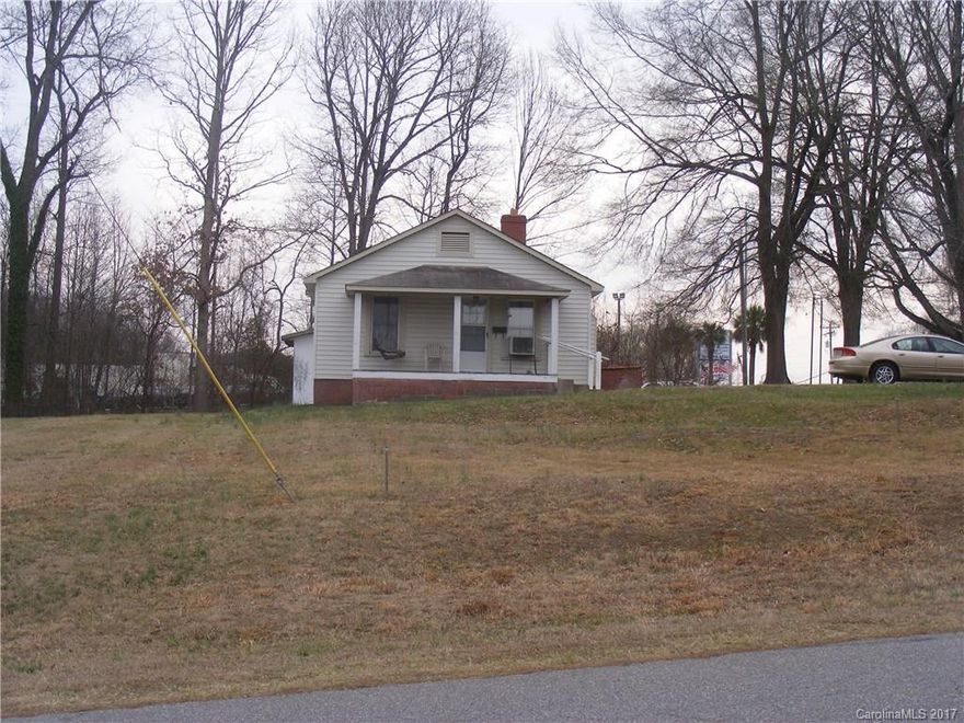 Zoned Highway Business! Two Lots and a small 1920's Home in good condition. Excellent Corner Location on US 21 between Brawley School Rd and NC 150. 1.25 miles from I-77. 2008 traffic count apprx. 19000 maybe more with new I-77 Exit 35 being built at I-77 and Brawley School Road.  245 feet on US21. 126 feet on Vandalia. Excellent mid volume location already zoned and in Mooresville City Limits! Existing house is well/septic but city water and sewer are available at street.
