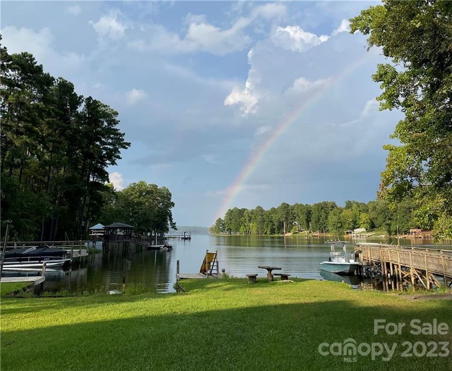 A double lot with a big view and 300+ feet of water frontage! The size of the property compliments the view down the cove to the main channel.In 2014, the home was completely renovated and the square footage doubled according to previous owners.Current owners have updated the home with new HVAC, fresh paint, LVP and updated kitchen.There is central vacuum and surround sound in the living room.Appliances and new washer and dryer remain. The covered front porch expands the length of the house on the water side and can be accessed from any room via french doors. Two huge bedrooms and 2 baths are downstairs, as well as laundry room, pantry, dining area and breakfast nook.The second level has 2 large bedrooms with shared bath, access to another covered porch and private entrance.Outside there's a metal garage with greenhouse, covered boat storage and great entertainment area! The property has an elaborate irrigation and drainage system, private well, dock, private boat ramp and swim area.