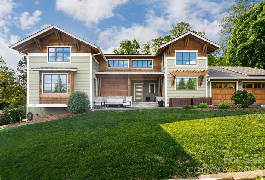 Jason Weil designed this house in 2016, not for a client but in conjunction with the builder who ultimately built it for himself and his family. They chose this half-acre site in North Asheville for its balance of year-round mountain views and wooded privacy.

The setting shapes the experience. Partially cleared and partially wooded, the upper levels sit within a natural canopy, treehouse-like in summer, with mountain views opening wide in winter.

The home offers five bedrooms, five and a half baths, and more than 5,100 square feet across three levels, including a private one-bedroom apartment with its own kitchen and separate entry.

Inside, a double-height entry with exposed beams and a floating staircase sets the tone. The main living area rises two stories, anchored by a fireplace and framed in timber and glass. It feels open and expansive, yet still grounded. The kitchen centers on an island that connects directly to the living space, with a walk-in pantry just off to the side.

From the two-car garage, a well-lit mudroom leads to the laundry and a tucked-away office nook, creating an everyday layout that is both practical and well considered.

The primary suite is on the main level, with a spa bath that includes heated floors, a curbless walk-in shower, and a soaking tub, along with a private balcony overlooking the mountains.

There is over 1000 sqft of outdoor living spaces beyond the 260 sqft screened porch. There is a back deck, with cable railings to preserve the treetop views, offering space for dining and cooking. From there, steps lead down to a stone patio, hot tub, and fire pit at the edge of the woods. 

Upstairs are two ensuite bedrooms, a loft, and flexible bonus space. The lower level includes two additional bedrooms, a family room, and the apartment, well-suited for guests, extended family, or rental use.

Morning light fills the front of the home, while afternoon sun settles across the back deck and into the woods beyond. Wildlife is part of the setting, with regular sightings of deer and turkey, giving the property a sense of being further out than it is.

Solar panels keep energy costs very low. The garage is finished with polished concrete floors, built-in storage, a workbench, and an EV charger. There is no HOA. The home is just minutes from North Asheville and Beaver Lake.

A well-built, thoughtfully maintained custom home, ready for its next chapter.

Showings start Saturday May 2nd.