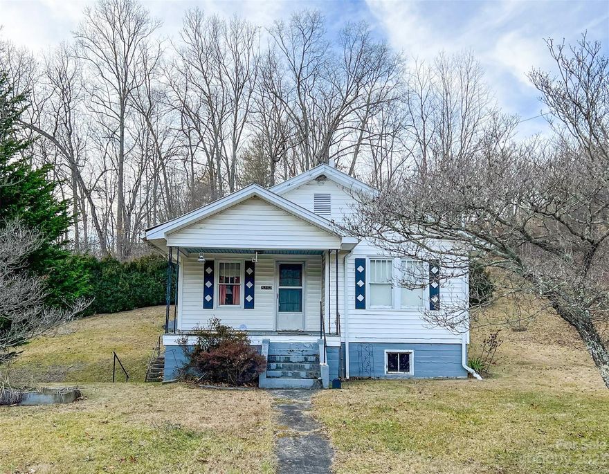 Very nice older home on +/- 2.55 acres at the corner of Penland Road and Rabbit Hop Road.  This 2BD/1BA home was remodeled in 2012, has spring on the property for water source and 3 outbuildings.  Walk-in shower in the upgraded large bathroom, canning room off the kitchen for mud room needs, & washer/dryer area. Poured solid concrete basement walls and foundation.