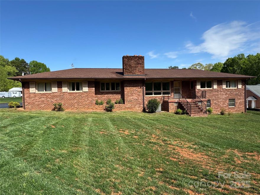 Investors and buyers who want to design their own space-this home is for you!  This brick ranch sitting on 1.04 acres with full basement has tons of potential.  3 bedrooms and 2 full baths on the main level.  2 Masonry fireplaces-one in the living room and one in the basement. Huge open basement that could be finished. Large yard-see new survey. Carport with space for two cars and utility closet with sink. Add your personal touches on this property to make it your own! Basement has a room plumbed for toilet, sink and shower. Washer/dryer hook up in the basement. HOME SOLD AS-IS-sellers will not make repairs.