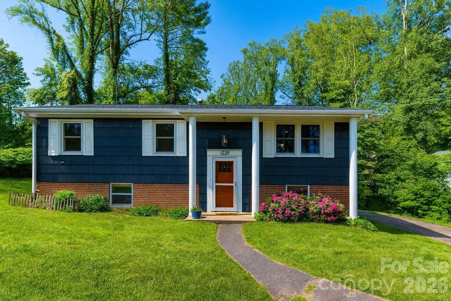 Discover the perfect blend of modern comfort and convenient access to Hendersonville’s vibrant offerings in this beautifully renovated 4-bedroom, 3-bath split-level home, tucked at the end of a quiet cul-de-sac just moments from downtown. Updated in 2021, this 1,800-sq-ft home features vinyl plank and wood floors throughout for a warm, cohesive feel.

The main level offers an inviting living room and dining area, along with an updated kitchen that shines with granite countertops, stainless steel appliances, and a stylish tile backsplash. This level also includes the primary suite, two additional bedrooms, and a hall bath.

Downstairs, a huge family room provides flexible space for movie nights, a play area, or a home office. A private fourth bedroom with ensuite bath is perfect for guests, and the spacious laundry room with built-ins adds everyday convenience.

Outdoor living is a standout, featuring a large covered deck—an ideal spot for morning coffee or evening gatherings—along with a generous green yard enclosed by privacy fencing and a stone walkway leading to a cozy fire pit.

Located just ½ mile from the newly opened Ecusta Trail greenway, Trailside Brewing, and a variety of local shops and restaurants, this home offers exceptional convenience and a dynamic lifestyle.

VA Loan at 3.75% is transferrable to VA qualified buyers!

Don’t miss this move-in-ready gem—schedule your showing today or reach out to learn more!