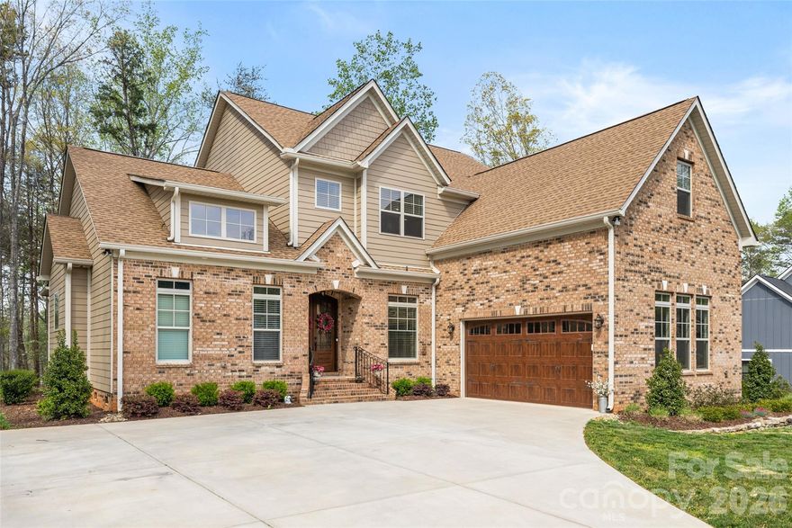 Welcome to this stunning two-story Mediterranean-inspired custom estate home, where timeless elegance meets modern comfort within a serene, private setting and over an acre of land. 

The grand double-door entry opens into an elegant foyer, where a private home office sits perfectly positioned at the front of the home - ideal for quiet productivity. Beyond, the residence unfolds into a breathtaking great room, highlighted by soaring 23-foot ceilings and a dramatic floor-to-ceiling stone fireplace with a solid wood mantle. The wall of windows floods the space with natural light, creating a warm and inviting atmosphere.

Designed for both everyday living and entertaining, the open-concept layout flows seamlessly into a chef’s kitchen featuring an oversized island with seating, gas cooktop with hood, double wall oven, stainless steel appliances, tile backsplash, and under-cabinet lighting. Enjoy casual meals in the cozy breakfast nook - complete with its own stone fireplace - or host elegant dinners in the formal dining room adorned with a tray ceiling and chandelier.

The main-floor primary suite is a true retreat, offering an oversized layout with tray ceiling and chandelier, along with a spa-inspired ensuite bath. Indulge in Italian marble flooring, a dual sink vanity, soaking tub, and an expansive walk-in shower with floor-to-ceiling tile.

Throughout the home, you’ll find refined architectural details including graceful archways, custom cabinetry, solid core doors, and designer blinds. The thoughtfully designed laundry room features custom tile, a utility sink, and ample cabinetry for added convenience.

Upstairs, a spacious loft and a large, finished bonus room provide flexible living space for recreation or relaxation. Two generously sized guest bedrooms share a beautifully appointed Jack-and-Jill bathroom with custom tile flooring.

Step outside to the enclosed patio just off the great room, complete with a ceiling fan and peaceful wooded views that lead down to a quiet pond. Whether kayaking, fishing, or simply enjoying quiet evenings by the water, this property offers a rare connection to nature.

Located within the exclusive Irongate community, residents enjoy gated access, scenic walking trails, and close proximity to Lake Wylie & Tega Cay.

This exceptional home combines luxury, privacy, and thoughtful design - an extraordinary opportunity to experience elevated living.