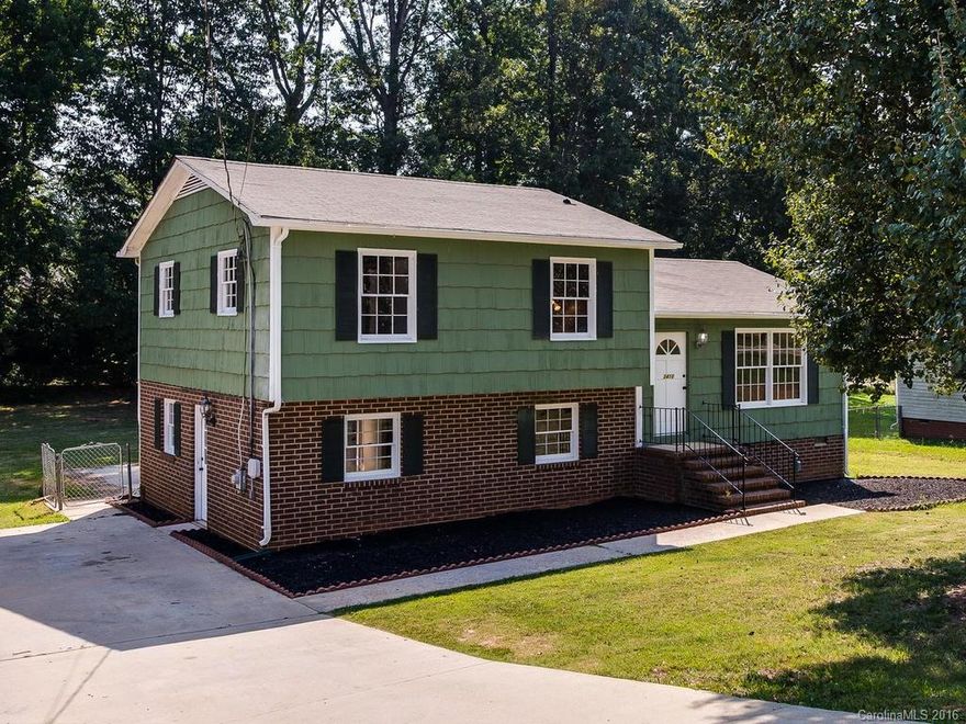 Beautiful brick & wood shingle home offers new floors, tile, fresh paint & oil rubbed bronze. Tall cabinets line Kitchen for storage. Meals are bright & sunny. Big upstairs Owners Suite & Bedrooms give everyone lots of room. Accessible open plan 2nd Living Quarters on lower level w/mini-kitchen & shared laundry. Big flat yard is fenced & fun for gatherings, ballgames & dogs. Excellent schools easy walk to shops, restaurants & ballfields. Just minutes to Airport & Uptown Charlotte. Move-in ready!