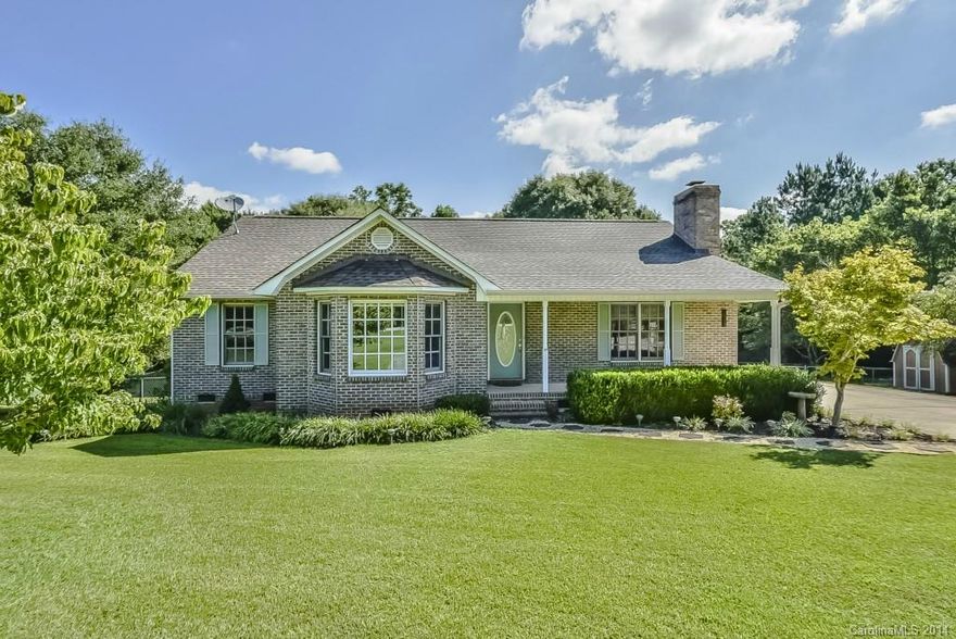 Brick ranch on 1 acre in the country, but still convenient to 77.  Large eat-in kitchen, living room with fireplace, master w/walk in closet, rocking chair front porch, back deck overlooks large fenced yard, detached storage building, partial basement & crawl space.