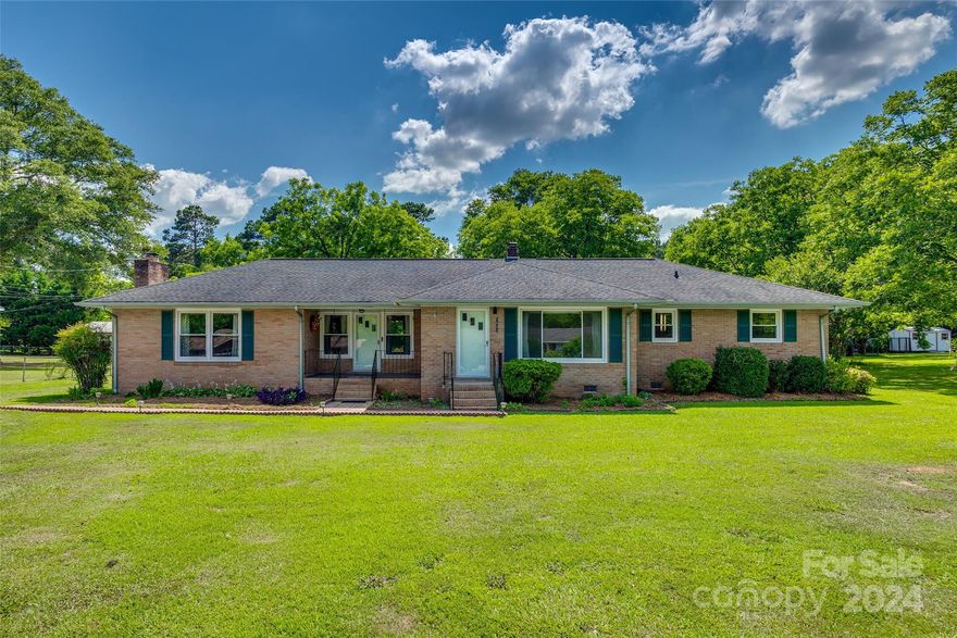 Nestled in the "Red Rose City" of Lancaster, SC, this mid-century ranch home embodies the classic charm and architectural integrity of its era. Built in 1960, this single-story residence seamlessly blends the warmth of mid-century living with modern functionality of modifications made by previous owners. With dual entry at the front of the home, access to the interior charm of this home is unlimited. This 3-bedroom, 1.5 bathroom home allows for plenty of space for living in either it's front living room or sunken bonus area. The central hub of the home is the kitchen and its dining area with plenty of living accommodations branching out on either side. To the right after the living room is a hallway leading to the bedrooms. With genuine hardwoods throughout, original colored tile in the bathrooms, and original rose/lilac tinted sinks and tub, this home contains many authentic touches from popular designs of yesteryear. Schedule a showing today to see this charming ranch home!