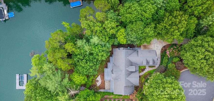 THIS IS THE LAKE HOME THAT CHECKS ALL THE BOXES... Open channel views, gentle/short walk to the waterfront/dock, privacy, lower living quarters w/ 2nd kitchen, 5beds/5.5 baths with nearly 5000 heated sqft! Upon arrival note how the home is situated offering great privacy & well thought out decks/stoned patio areas. Note the home offers lake views from the entire back of the home. On the main you have vaulted & 9-12 foot ceilings along w/ an open concept layout. Even better on main a spacious eat-in kitchen, all weather room, 1/2 bath/ formal dining, office, 2 bedrooms (primary)/2 baths, & laundry. The primary boasts deck exit, views, en suite bath w/ custom tiled shower, Jacuzzi, & walk-in closet. On 2nd floor the bonus/bedroom w/ full bath. Lower level provides secondary living quarters w/ a full kitchen, 2 baths, family room w/ 2nd fireplace, workshop, storage rooms & more. Note the home has real hardwoods, Trex decking, lighted walk/dock w/ HydroHoist lift, 176 ft. of waterfrontage.