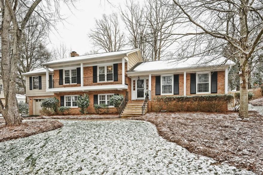 Gorgeous all brick home in highly desirable neighborhood offers great outdoor living space.  Beautifully landscaped yard surrounded by new fence with custom stone patio,  beautiful water feature w/ lights  Main level has refinished hardwoods floors, large entertaining areas, updated kitchen with granite counters and upgraded hardware and finishes.  There are five bedrooms with extra flexible rooms now being used as music room and office. All bathrooms updated. Oversized garage, plenty of storage