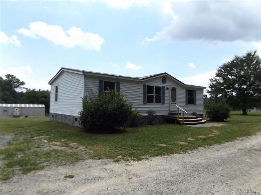 Neat doublewide in the heart of apple country. Country setting. New Metal roof. Block and stucco foundation with vinyl siding. Updated kitchen including cabinets and countertops. Jetted bathtub and shower in master. Come add your finishing touches to make it home. Minutes to downtown, but in the quiet countryside. Shared well agreement to be recorded, private gravel road.