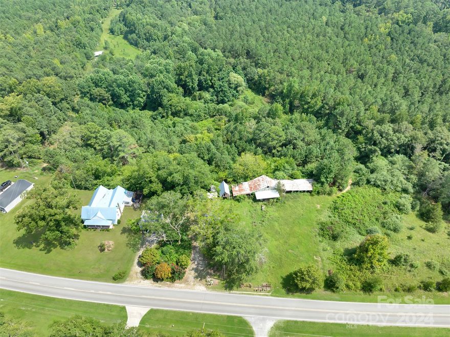 3 Bedroom 2 Bath Ranch on 14.25 Acres with several outbuildings.  The home has 2,000 sq ft with open kitchen and living room.  Appliances included, New HVAC in 2023.  The home has a metal roof and a front porch.  The home does need TLC but if you are looking for acreage this is the place for you!  Beautiful country setting!